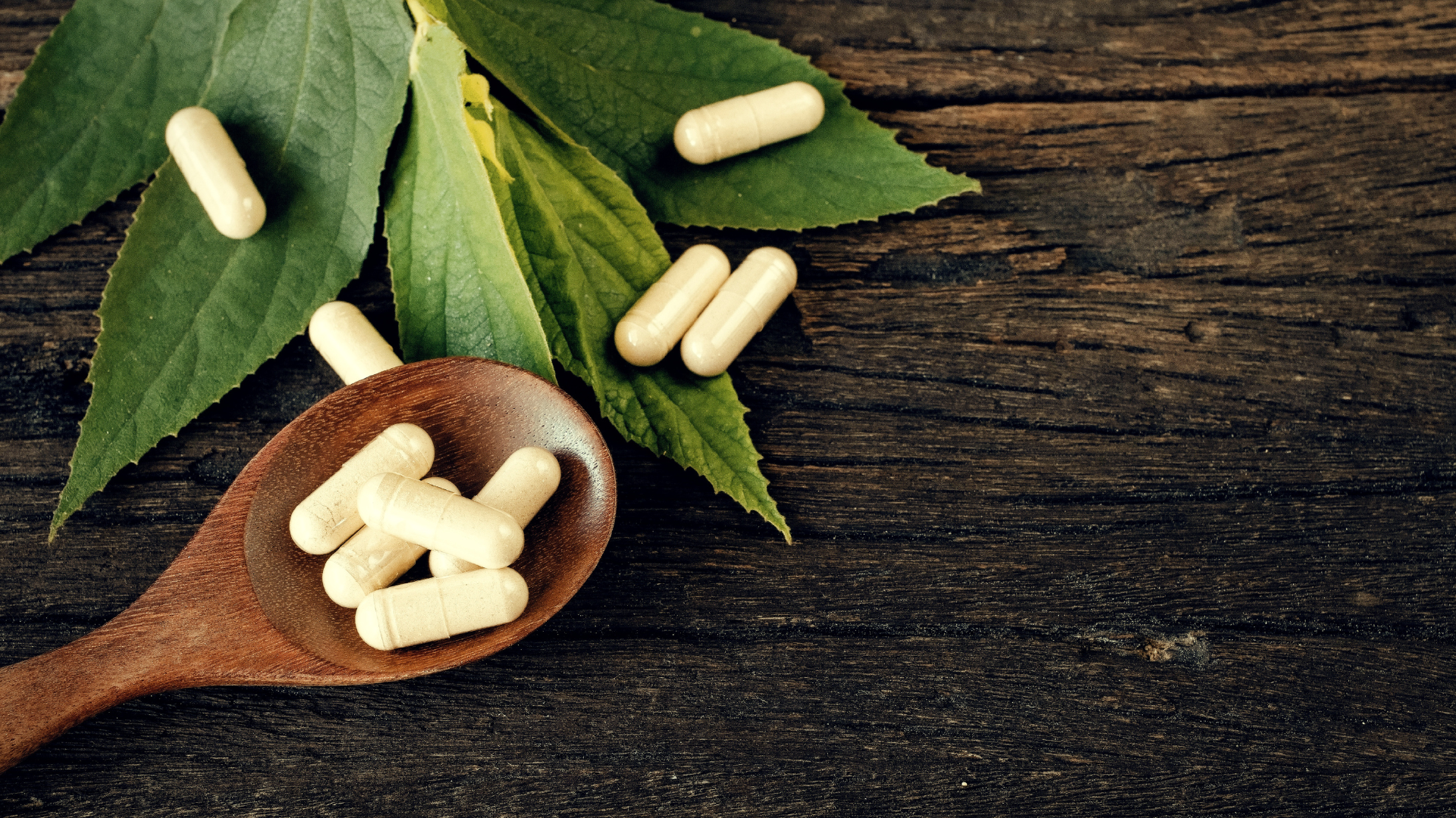 Pharmacy at SPAR medicine capsules on a wooden spoon with herbal leaves